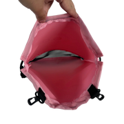 Pink drawstring bag with a hand pulling on the top, white background