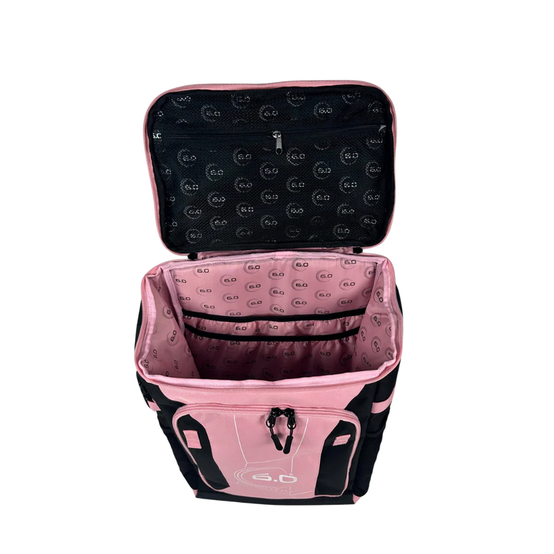 Pink and black backpack with open lid on a white background
