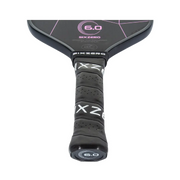 Close-up of a SixZero pickleball paddle with branding and model number on a white background