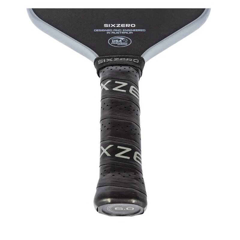 Close-up of a Sixzero pickleball paddle with branding on a white background