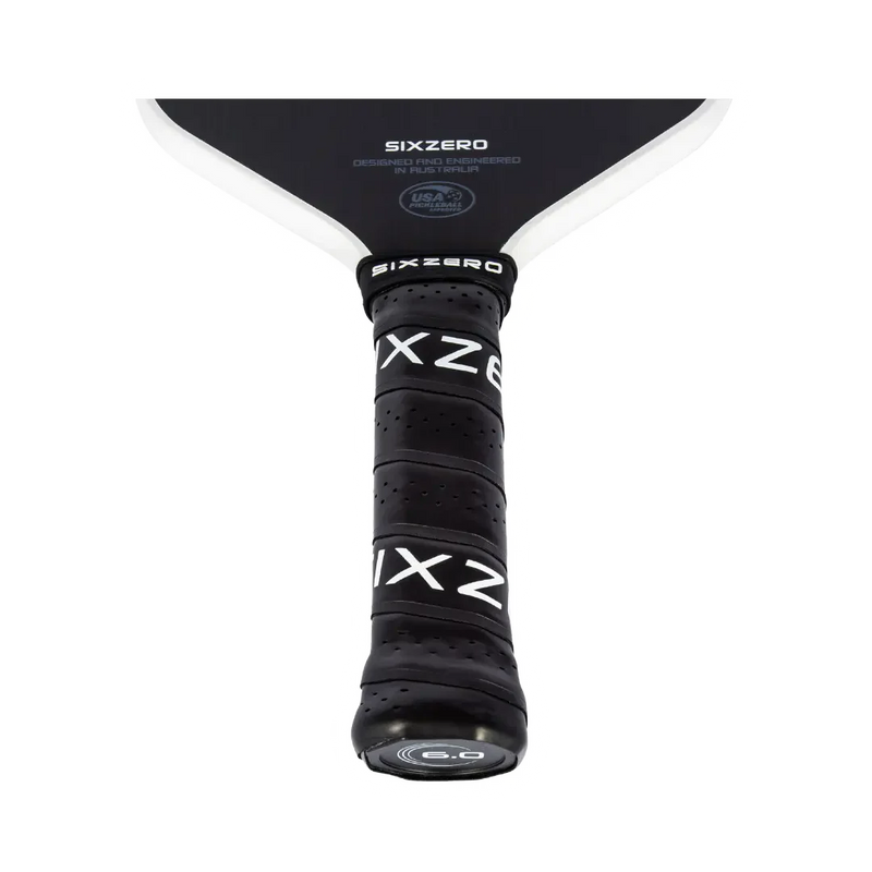 Close-up of a Sixzero pickleball paddle with black and white design on a white background