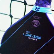 Close-up of a sports shoe with branding and text against a blurred net background