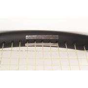 Close-up of a tennis racket with a white background
