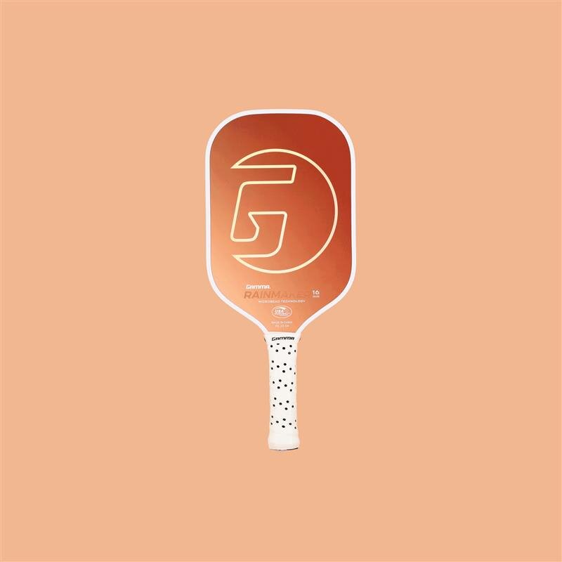 Pickleball paddle with a brand logo on a peach background