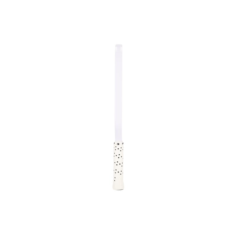White candle with black polka dots on a white background