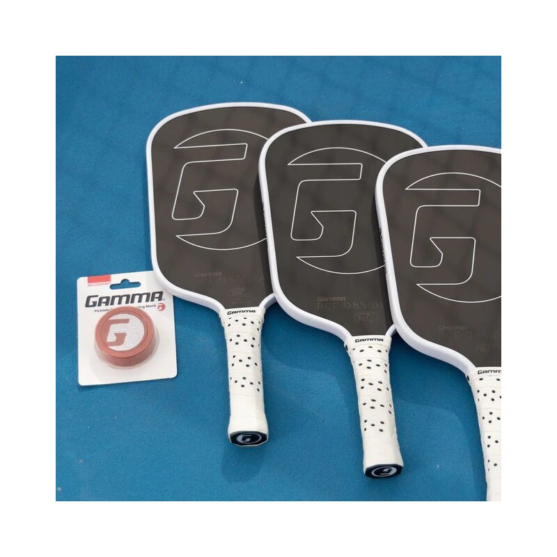 Three pickleball paddles with a Gamma brand packaging on a blue background