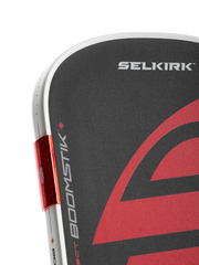 Close-up of a Selkirk paddle with red and black design on a white background