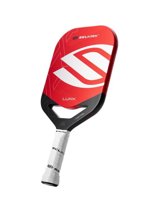 Red and black paddle with 'Selkirk' branding on a white background