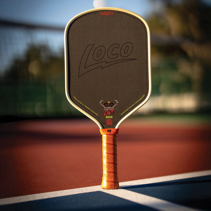 Pickleball paddle with 'Loco' branding on a court