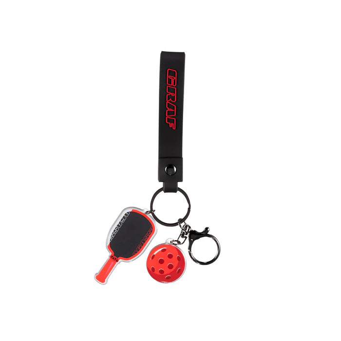 Keychain with paddle and ball charm on a white background