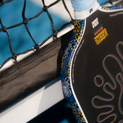 Close-up of a paddle with branding against a blue background