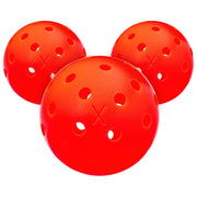 Three red perforated balls on a white background