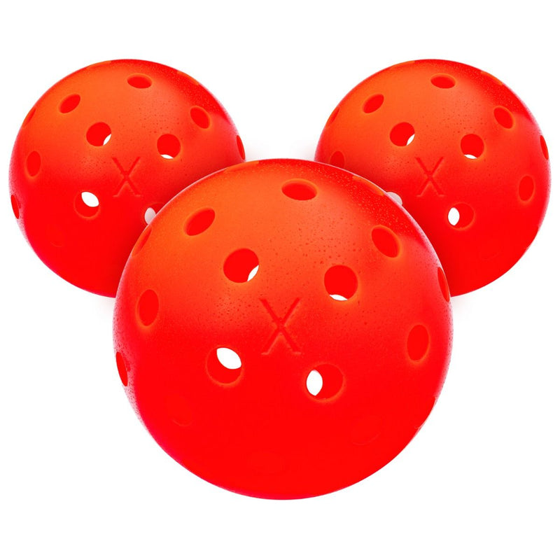 Three red perforated balls on a white background