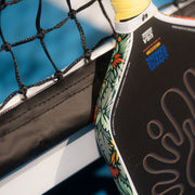 Close-up of a paddle with floral design on a blue background