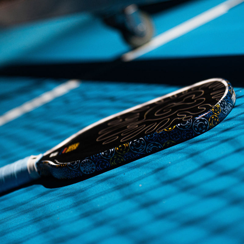 Close-up of a paddle on a blue surface