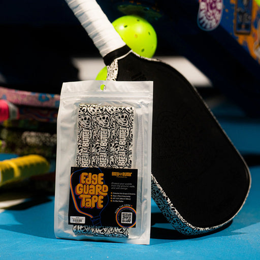 Packaged Edge Guard Tape with a paddle and ball on a blue surface