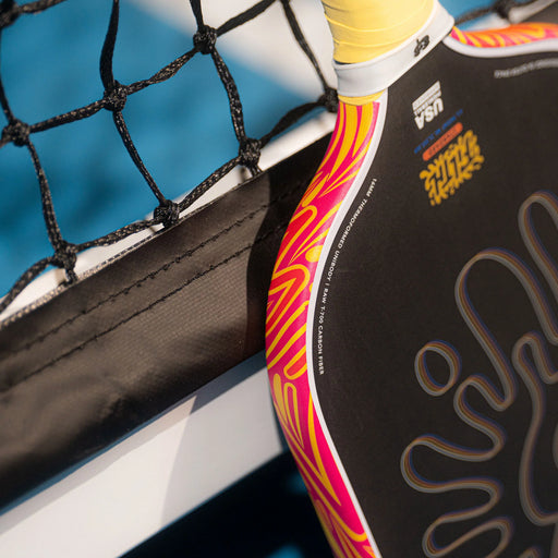 Close-up of a paddle with colorful design against a blue background