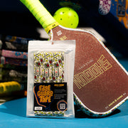 Pickleball paddle with Edge Guard Tape packaging on a blue surface