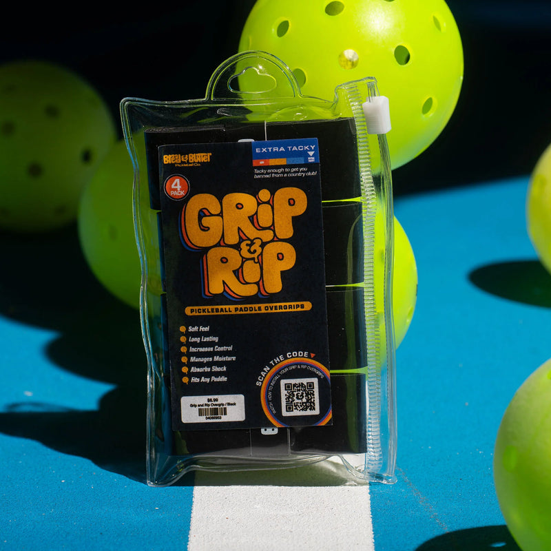 Packaged Grip It Rip on a pickleball court with balls in the background