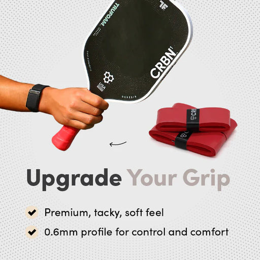 Hand holding a pickleball paddle with a red and black grip, and additional grips displayed below on a light gray background.