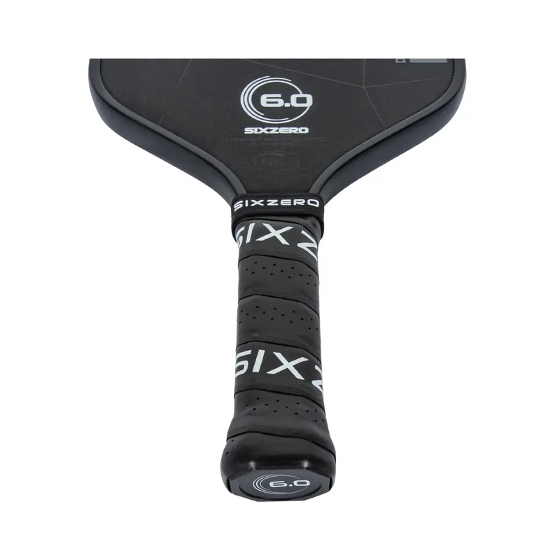Close-up of a black pickleball paddle with 'Sixzero' branding on a white background