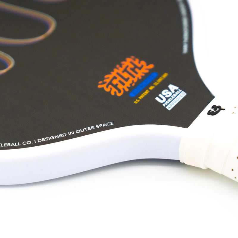 Close-up of a picklball paddle with branding on a white background