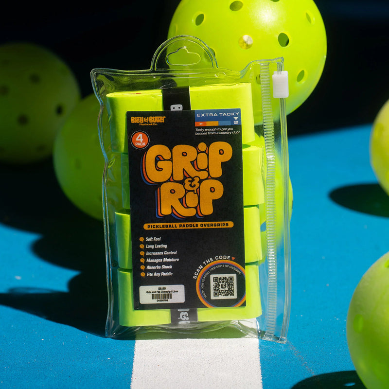Packaged Grip & Rip pickleball paddle overgrip with pickleballs in the background on a blue surface.