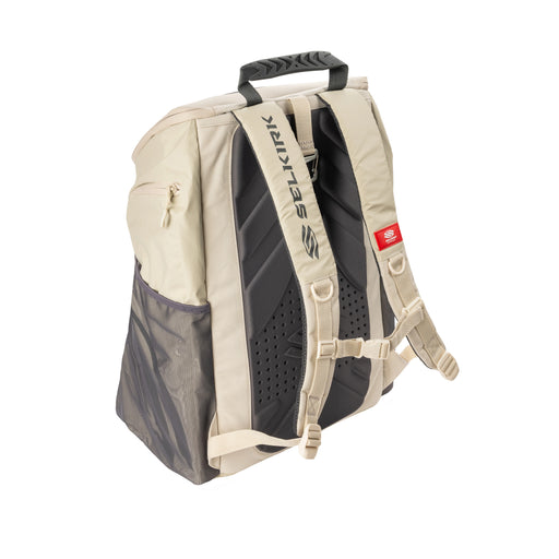 Beige and black backpack with visible branding on a white background