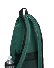 Green backpack with a water bottle in a pocket on a white background