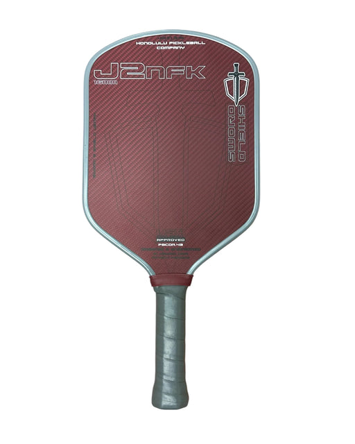 Red pickleball paddle with branding on a white background