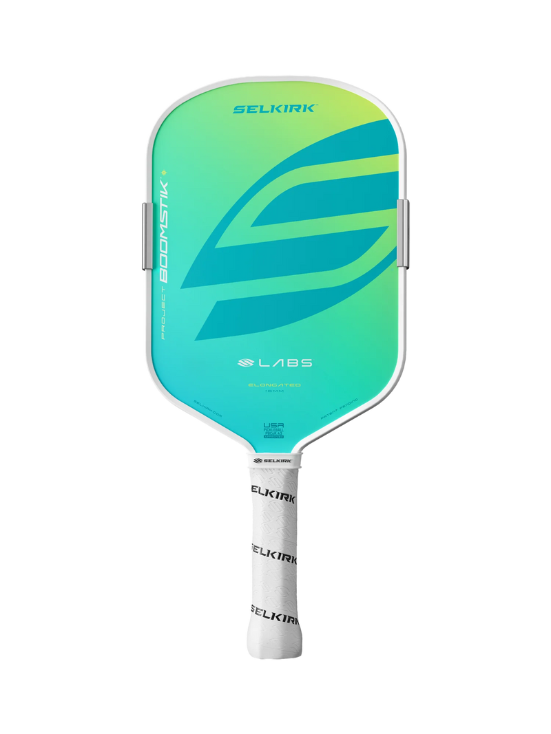 A Selkirk Boomstik LABS pickleball paddle featuring a vibrant green and blue gradient face, a white frame, and a white wrapped handle on a solid white background.