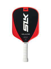 Red and black pickleball paddle with white handle on a white background