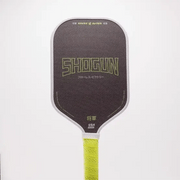 Pickleball paddle with 'Shogun' branding on a white background
