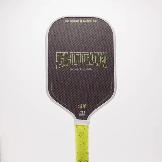 Pickleball paddle with 'Shogun' branding on a white background