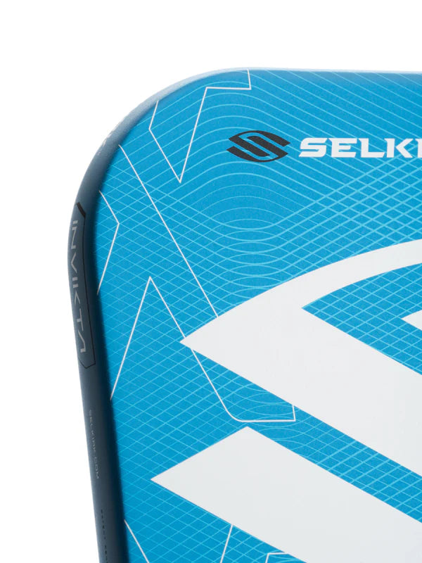 Close-up of a blue and white pickleball paddle with 'Selkirk' branding on a white background