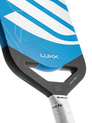 Close-up of a blue and black pickleball paddle head with 'Luxx' branding on a white background