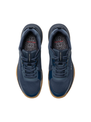 Pair of navy blue athletic shoes with brown soles on a white background