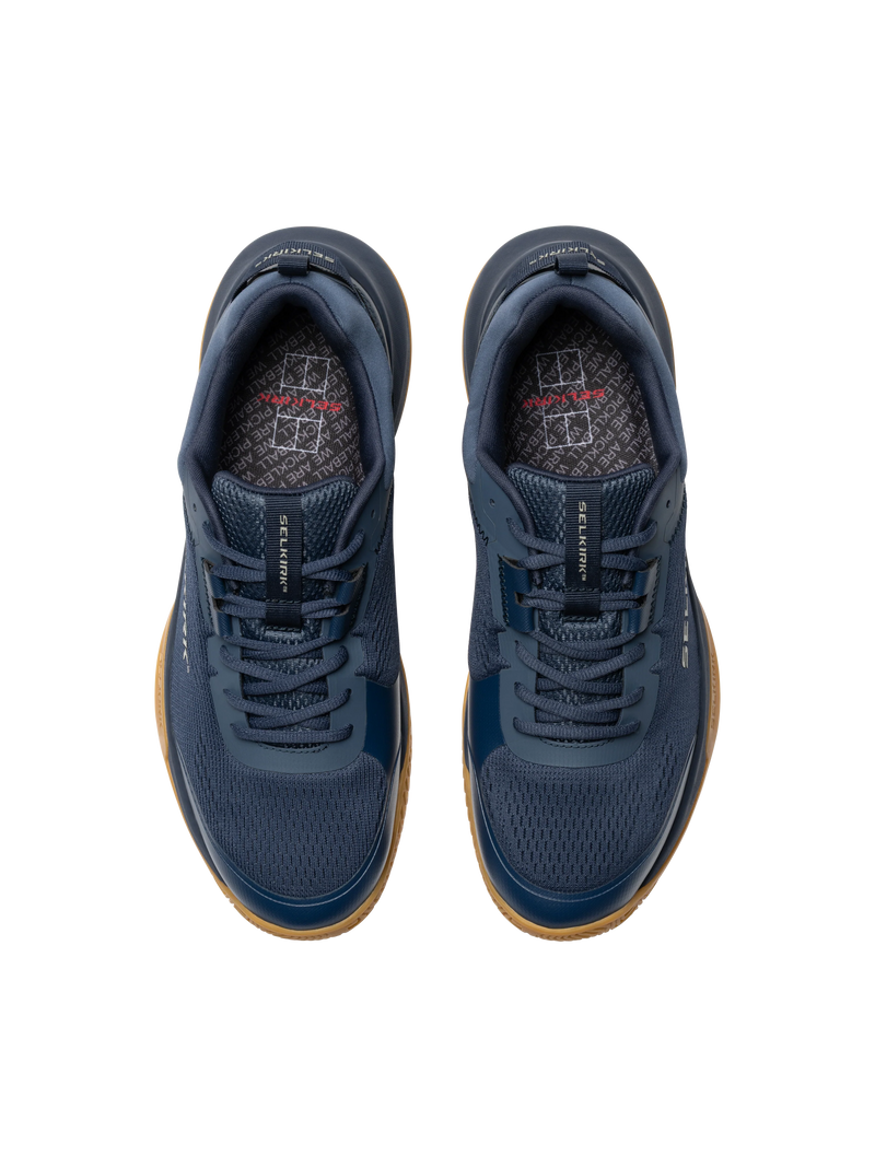 Pair of navy blue athletic shoes with brown soles on a white background