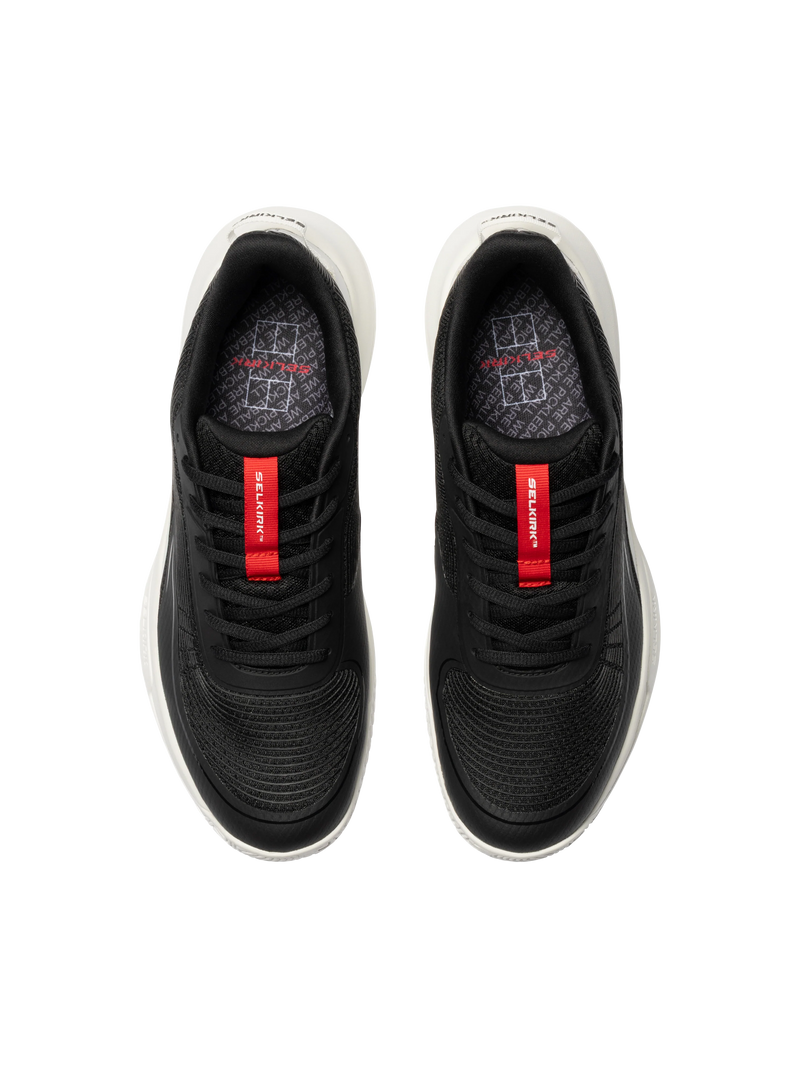 Black athletic shoes with red accents on a white background