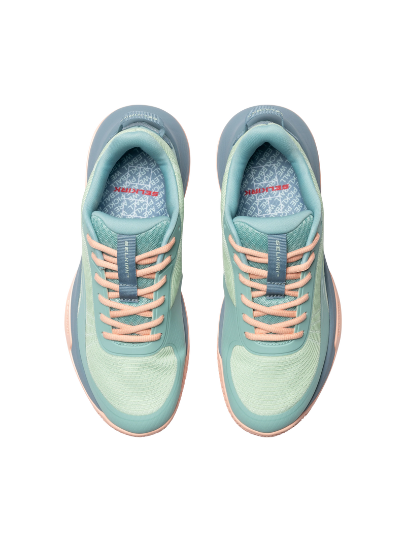 Pair of light blue running shoes with pink laces on a white background
