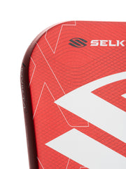 Close-up of a red paddle with 'Selkirk' branding on a white background