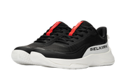 Black and white sneakers with red accents on a white background
