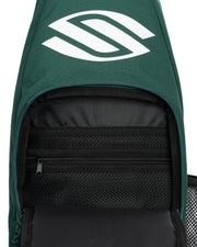 Green backpack with a logo on the top and open front compartment showing black interior.