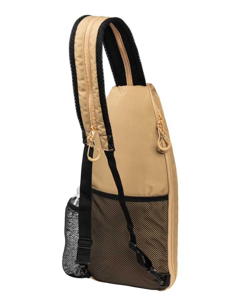 Beige sling bag with black straps on a white background