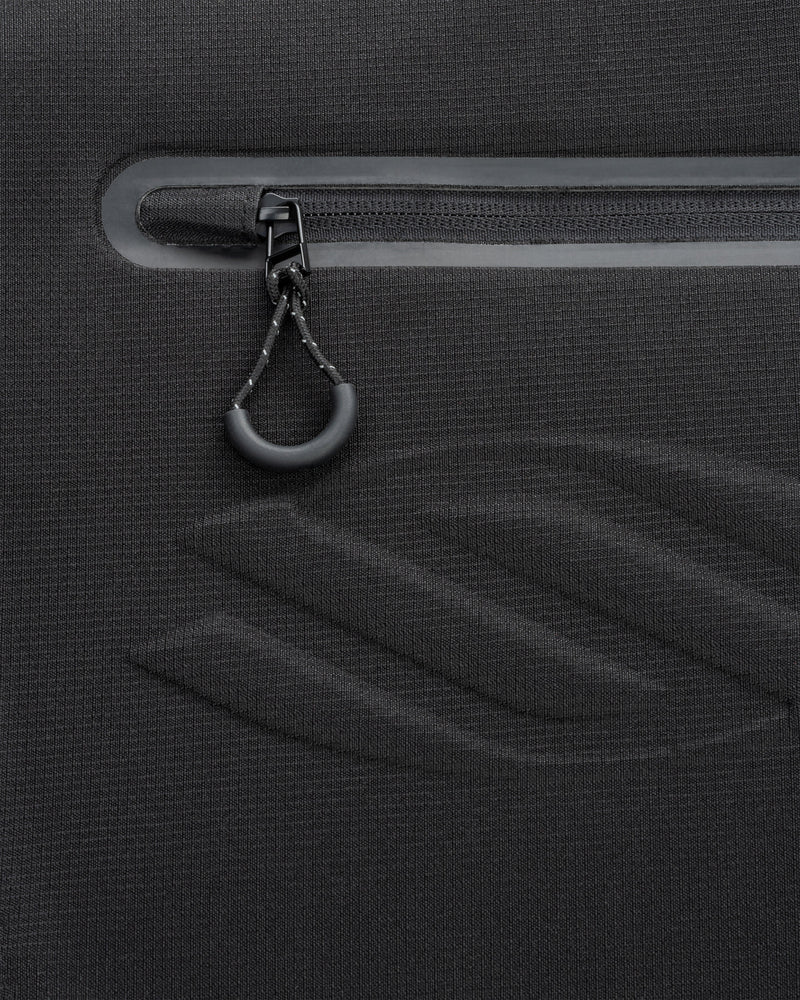 Close-up of a black zipper on a textured surface