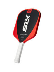 Red and black pickleball paddle with white handle on a white background
